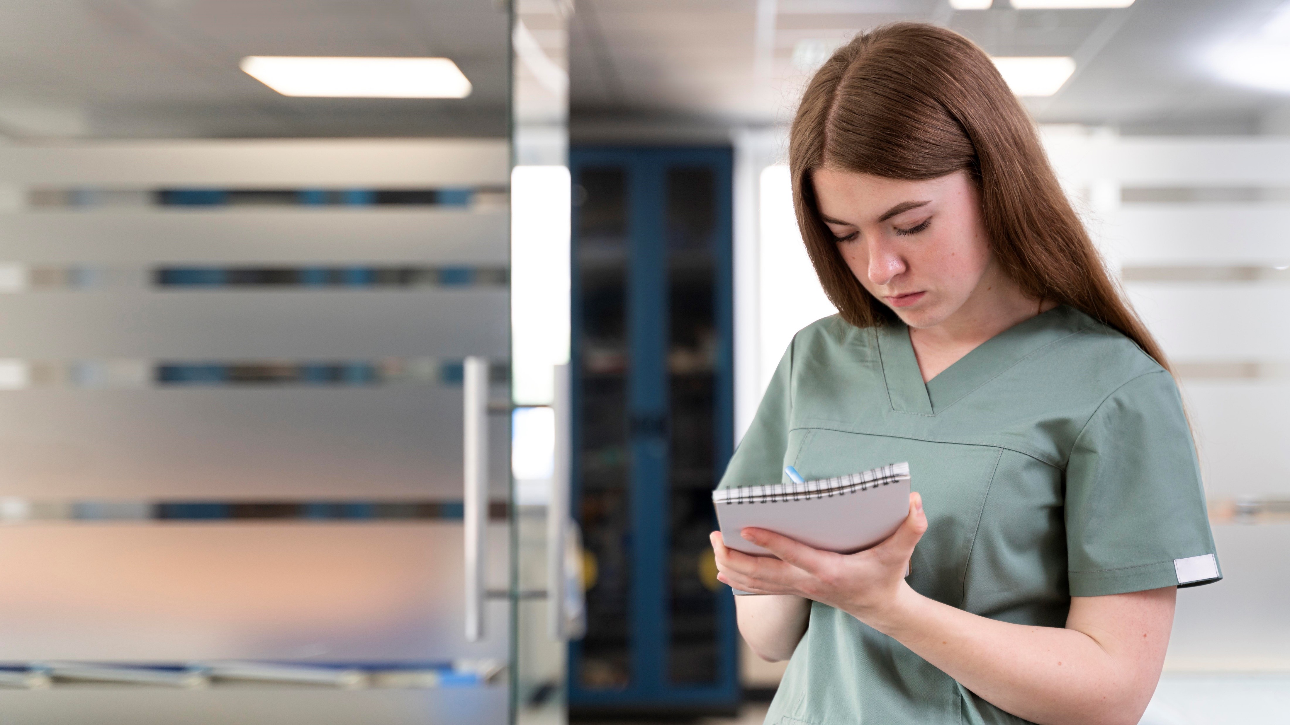 Nurse writing her tasks in a notebook