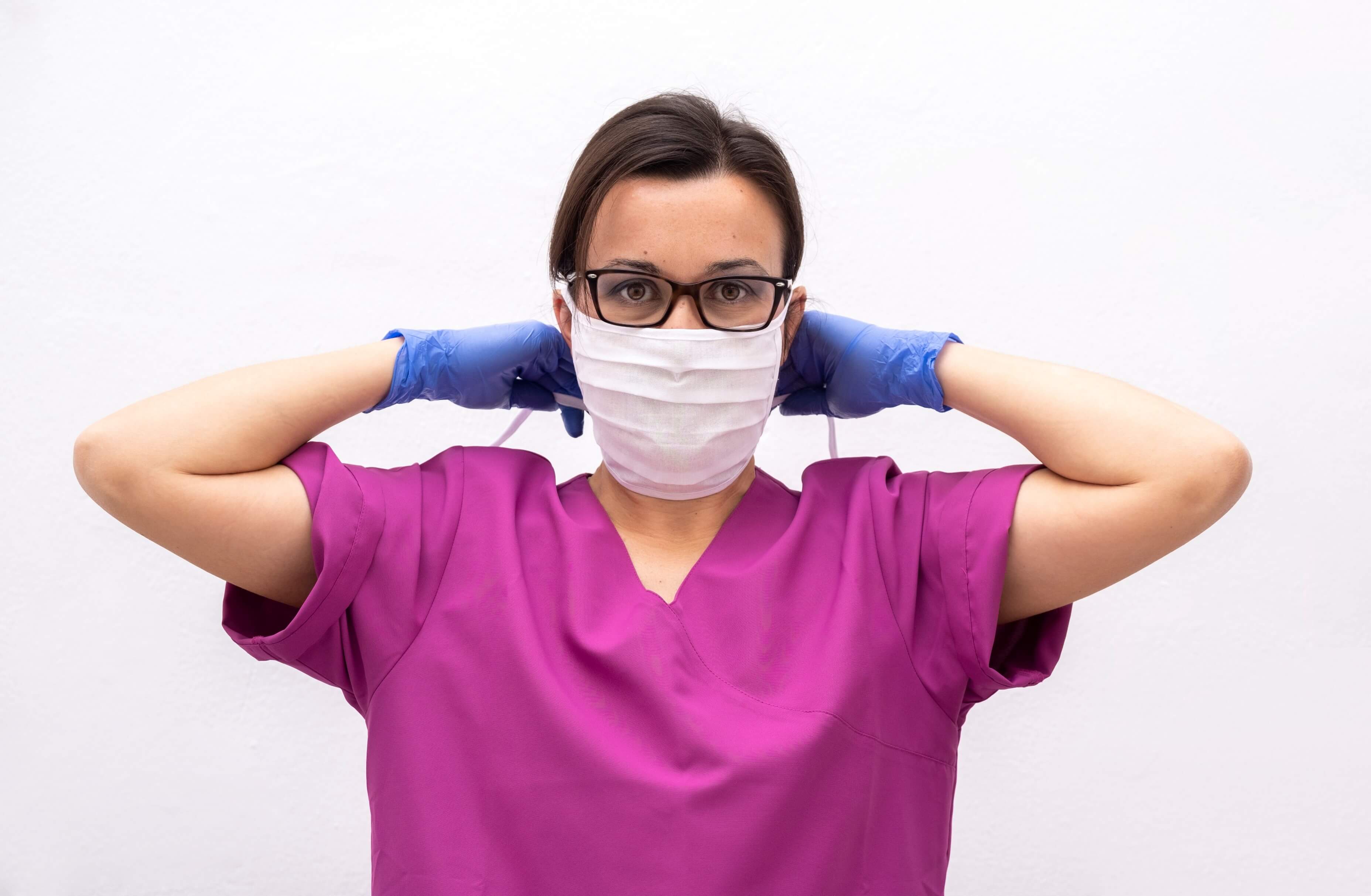 Nurse putting on mask
