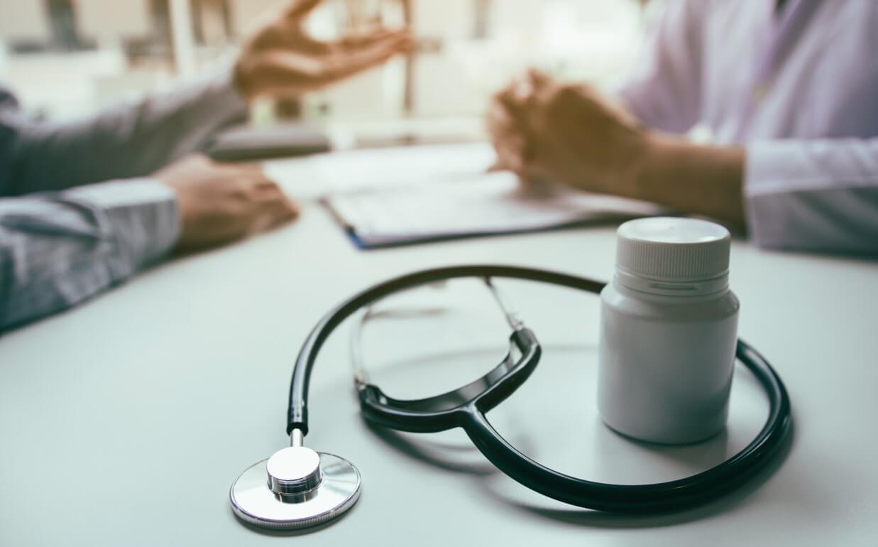 Close up of stethoscope and medicine bottle