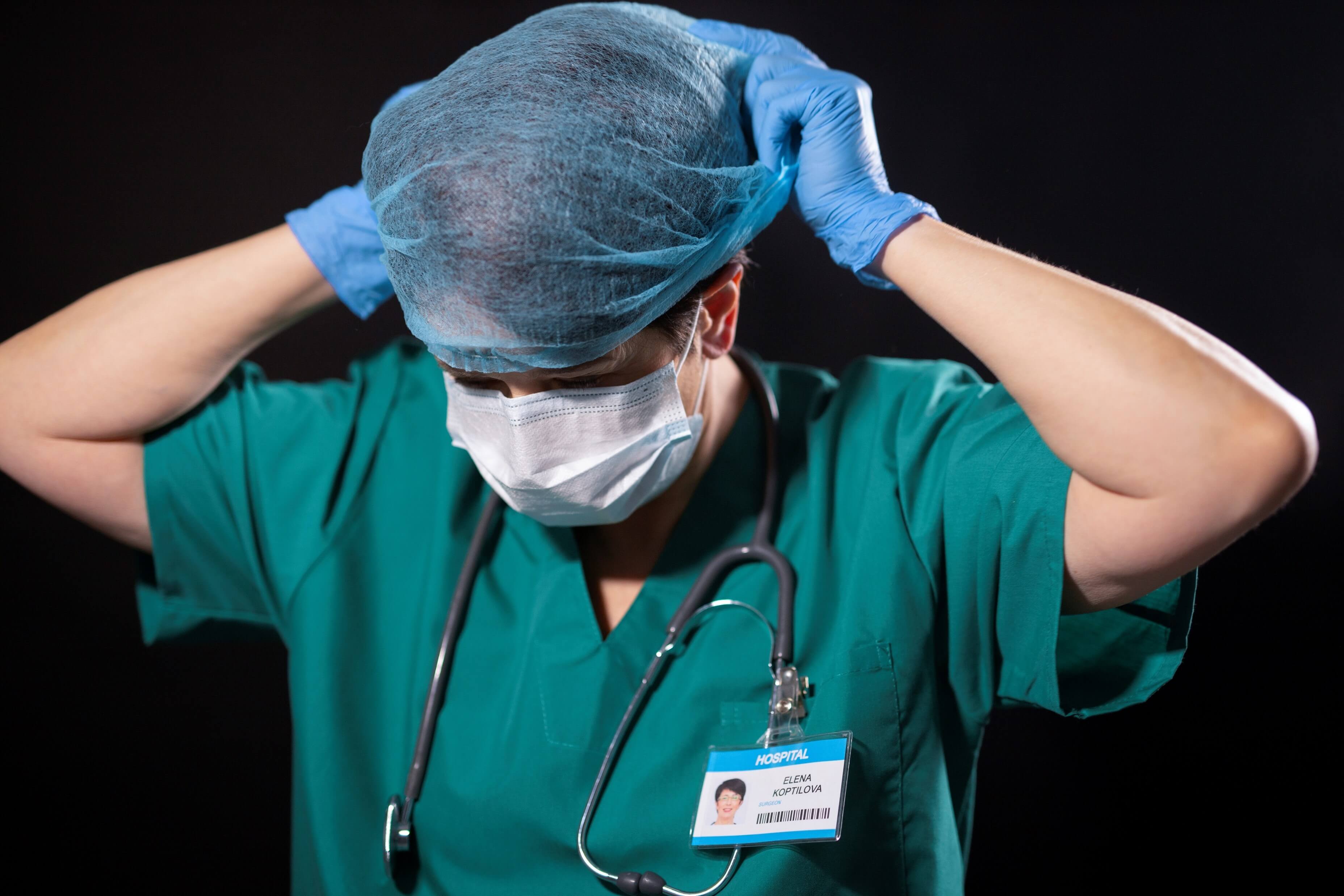 Nurse putting on mask