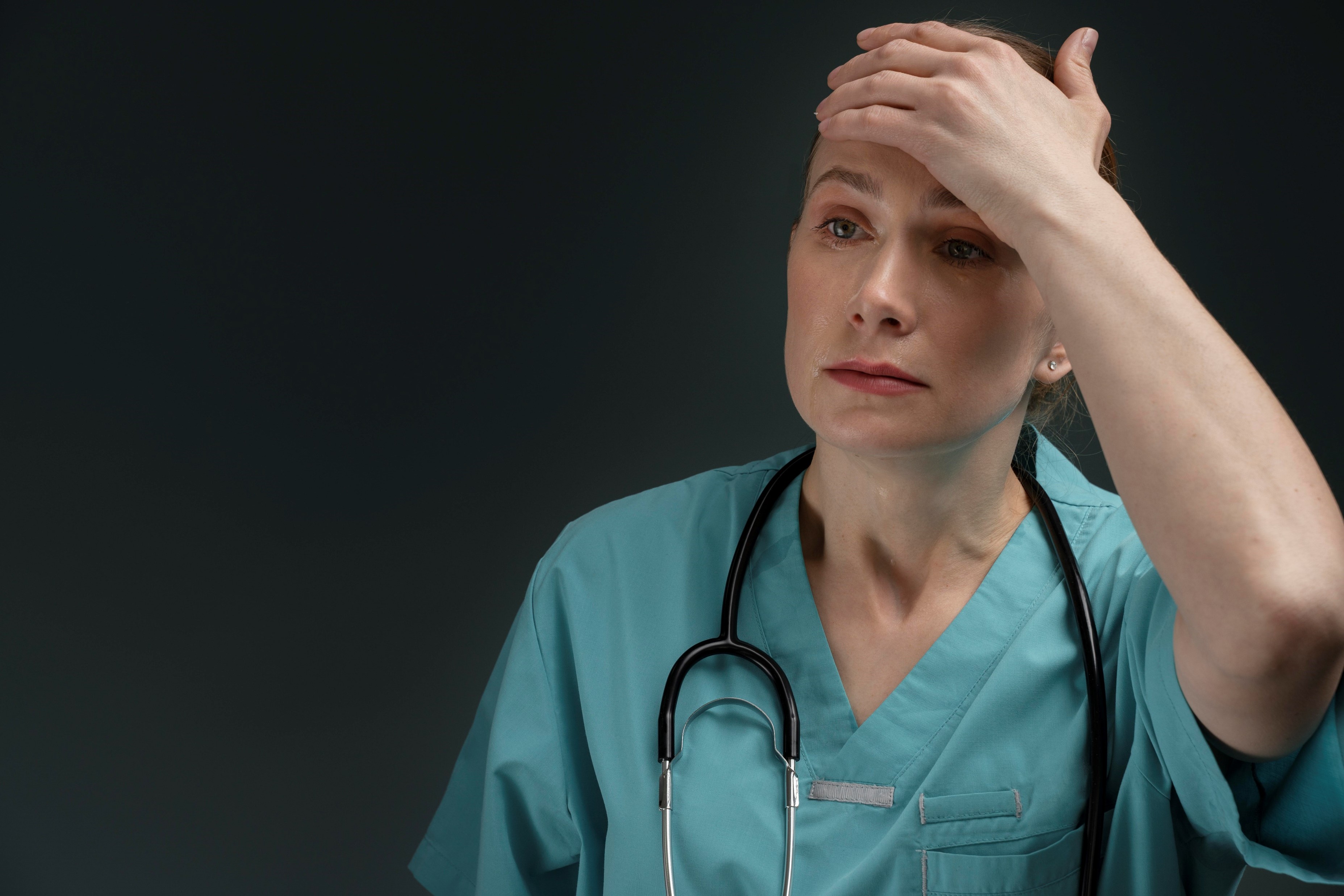 Frustrated nurse with stethoscope on her neck