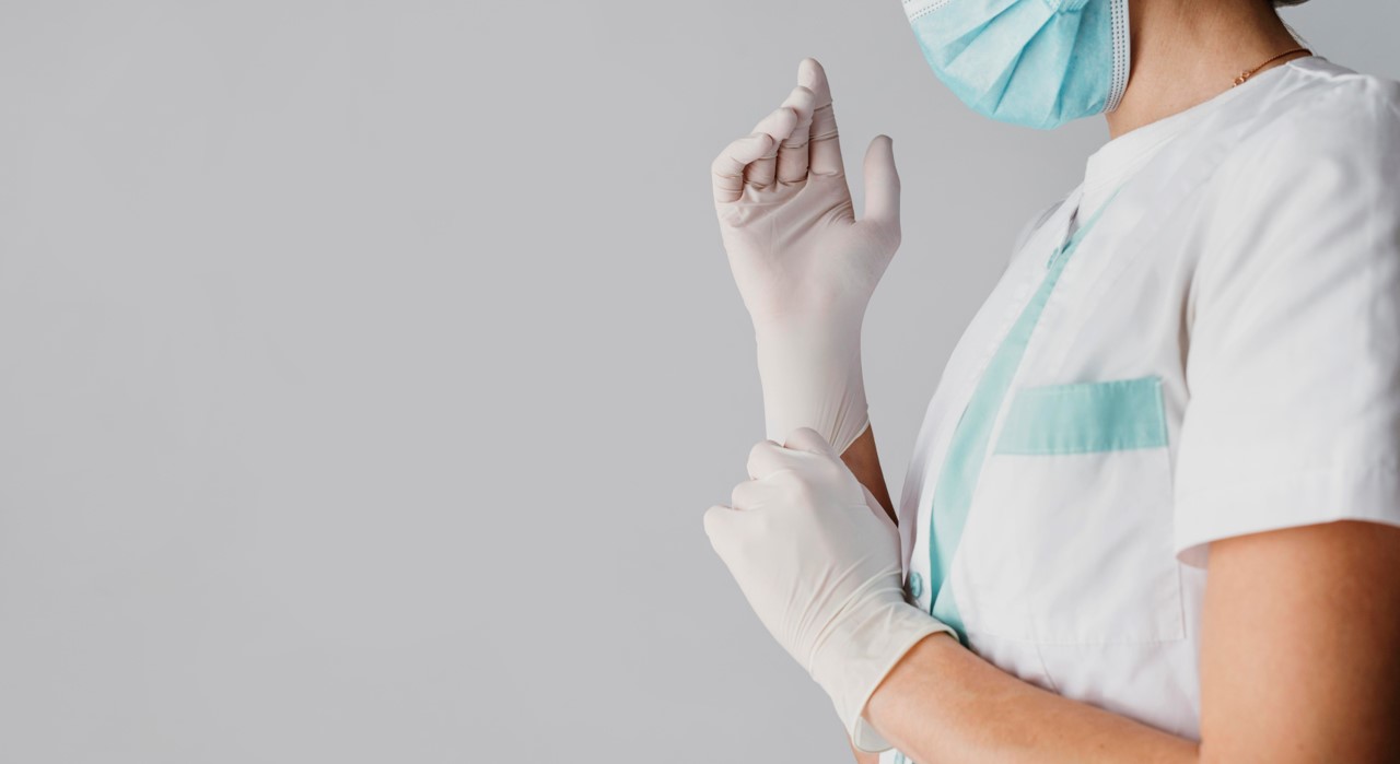 Nurse putting on gloves