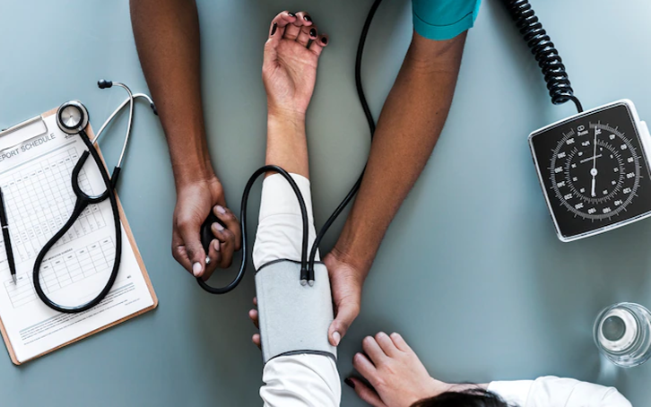 Nurse measuring patient blood pressure