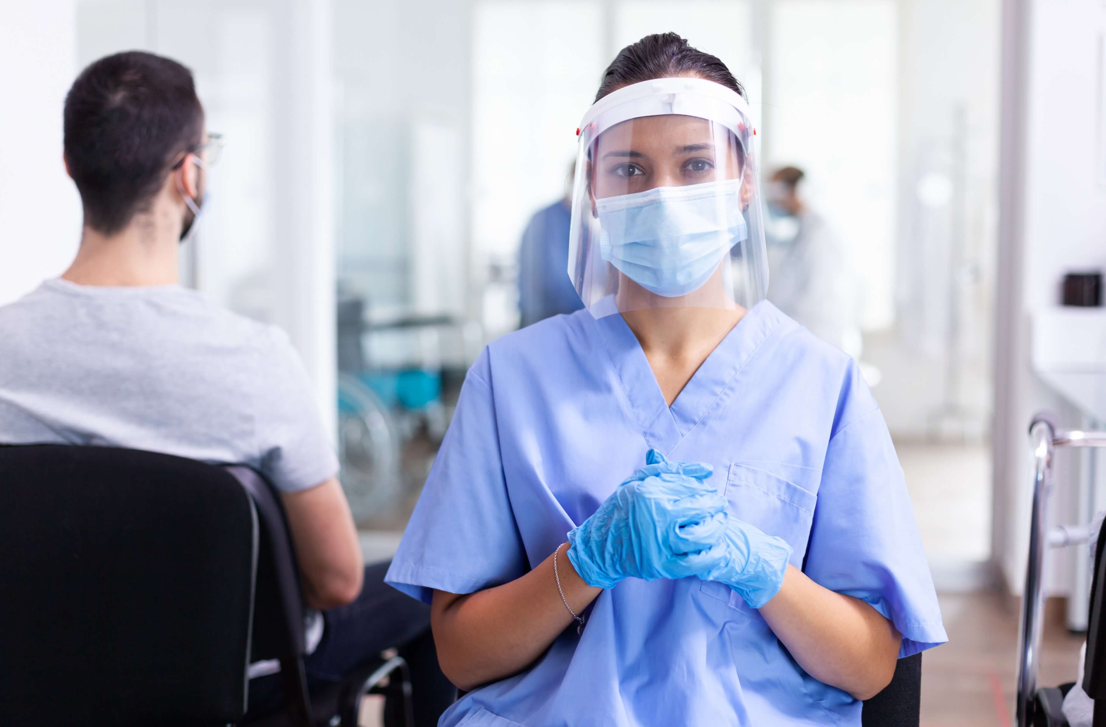 Nurse wearing faceshield looking at the camera