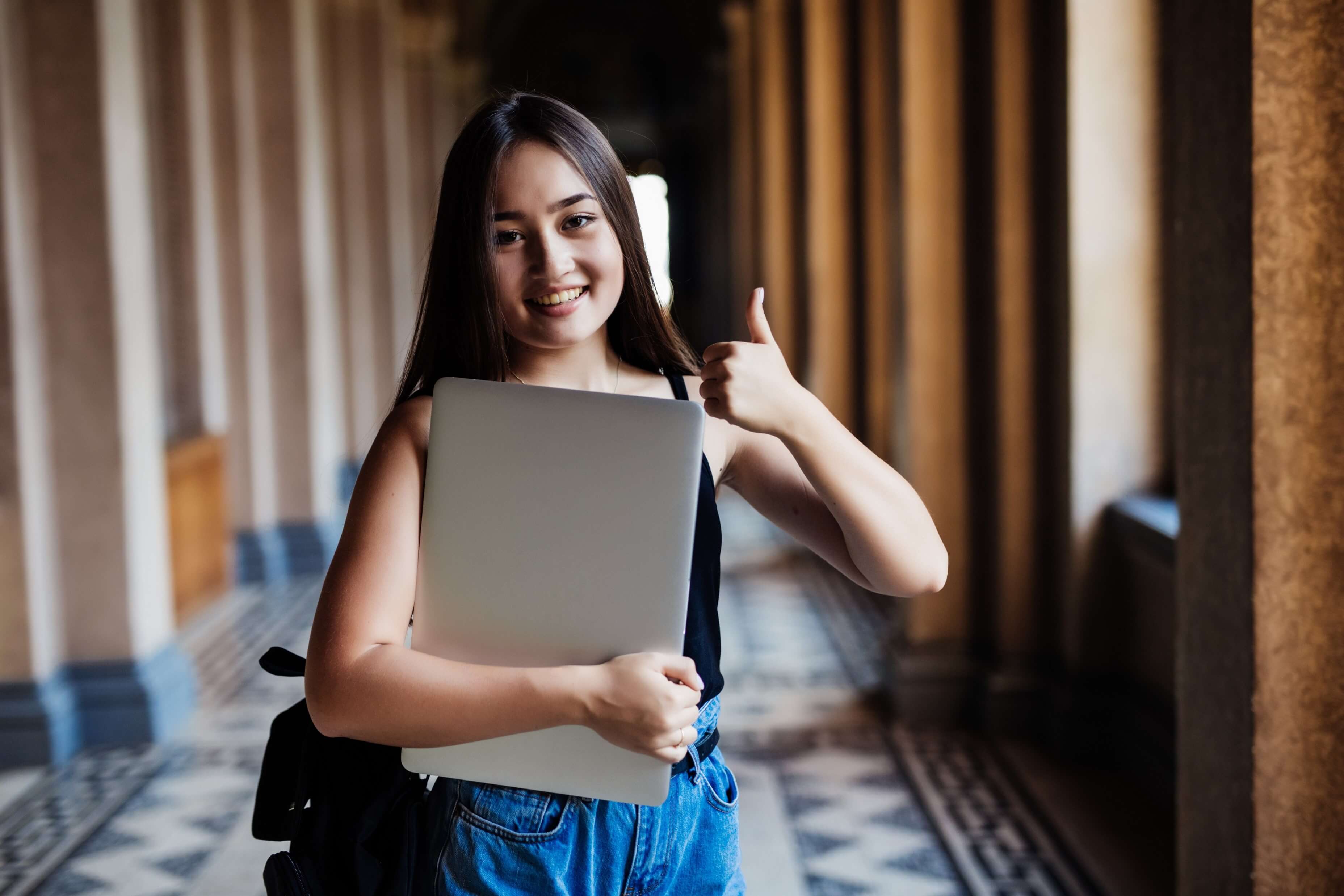 Young woman smiling in front of a camera