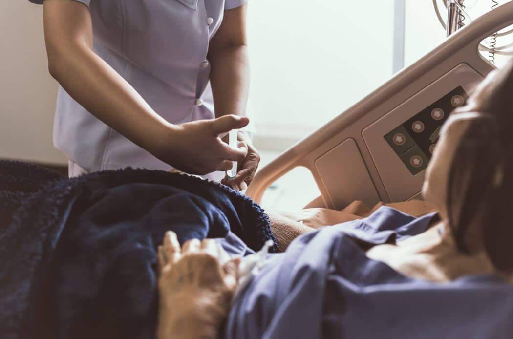Nurse giving an injection to a patient at the hospital