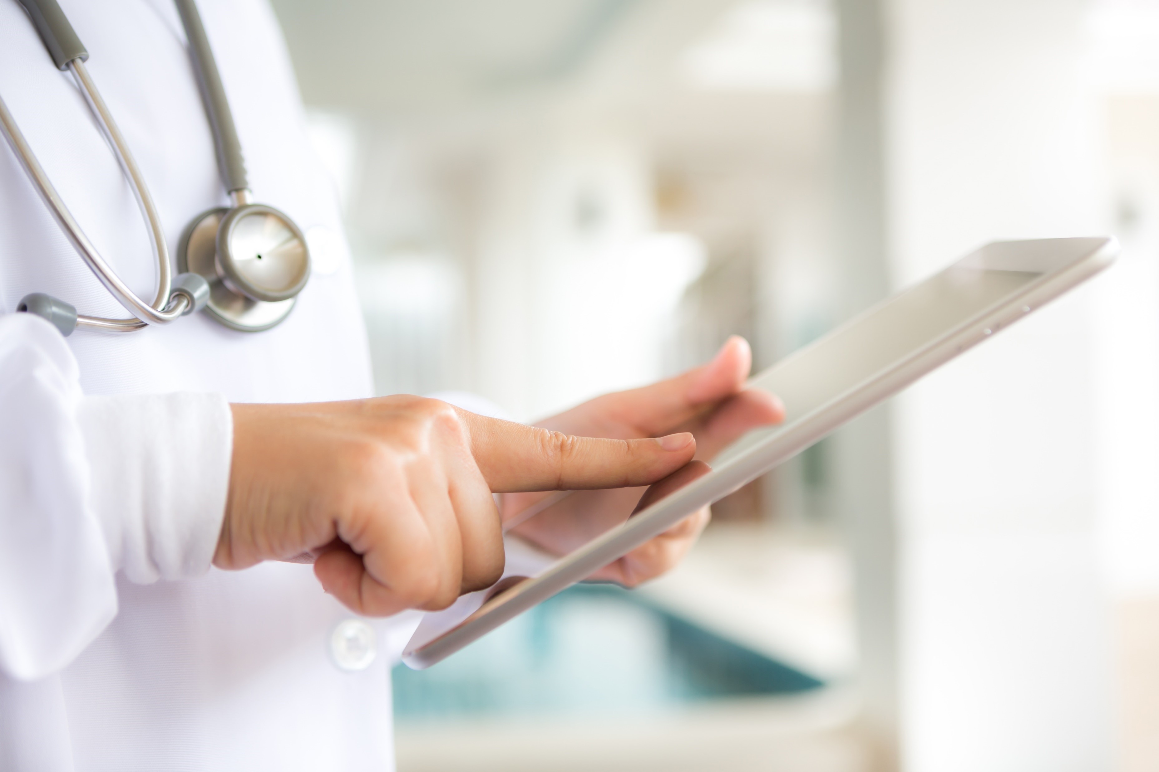 Close up nurse using tablet